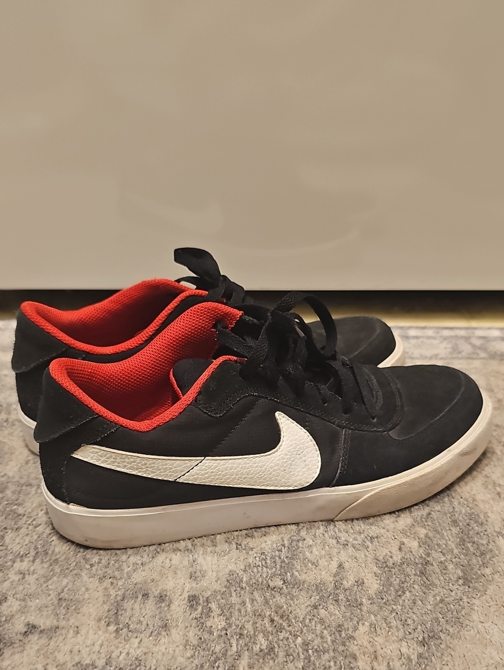 Nike Black Sneakers with White Swoosh and Red Lining